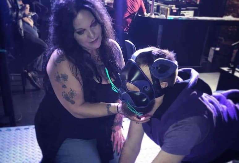 Former Ms. Iowa Leather Bettie Rage and kitty play