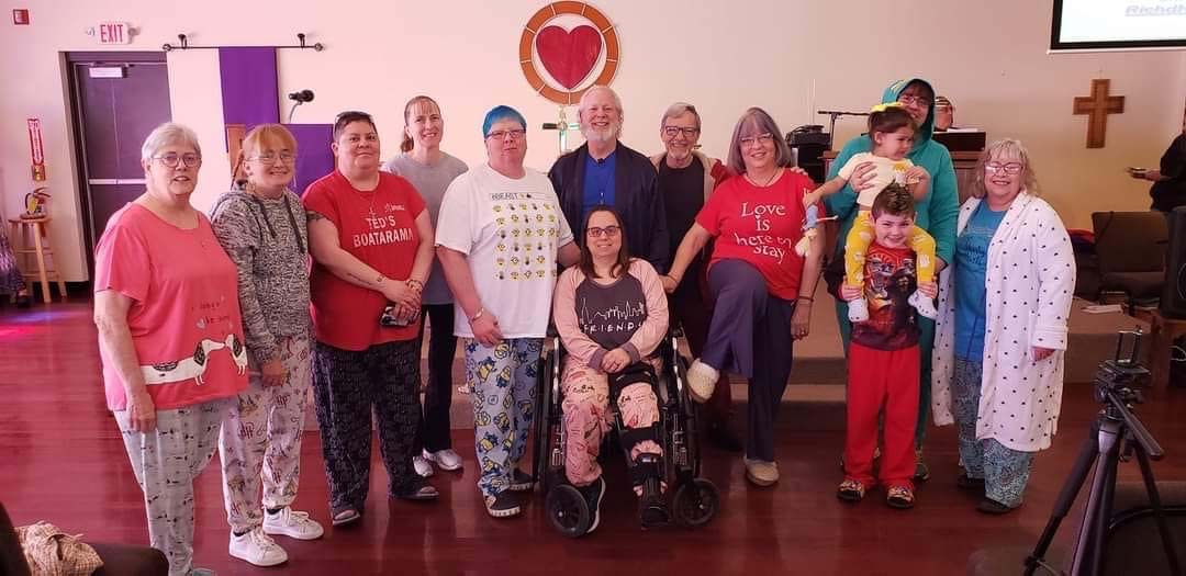 Sara Meyer (far left) has been a member of MCC of the Quad Cities for 21 years and attends almost all of its events, including Pajama Day. Pastor Rich Hendricks is in the center.