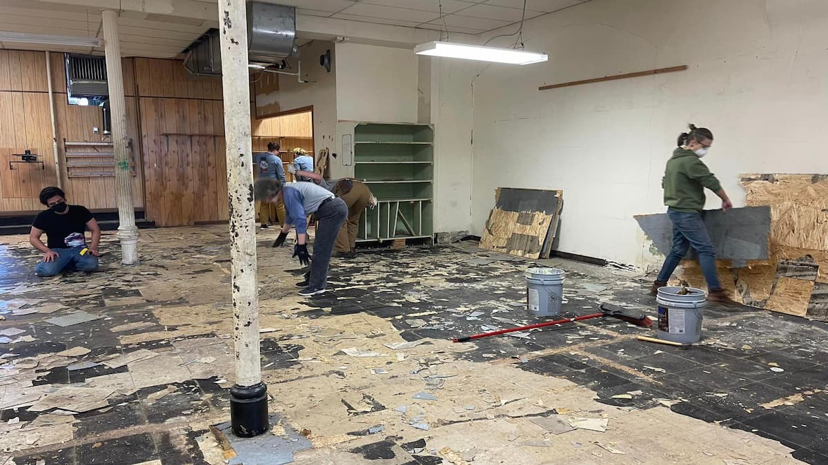 Volunteers tackle floor replacement at the new headquarters for Rainbow Cafe LGBTQ Center.