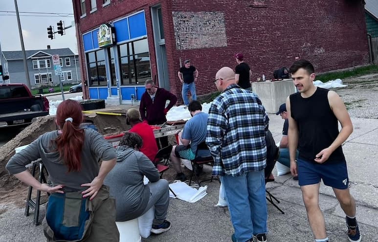 Volunteers helping to fill sandbags at Mary's on 2nd in Davenport