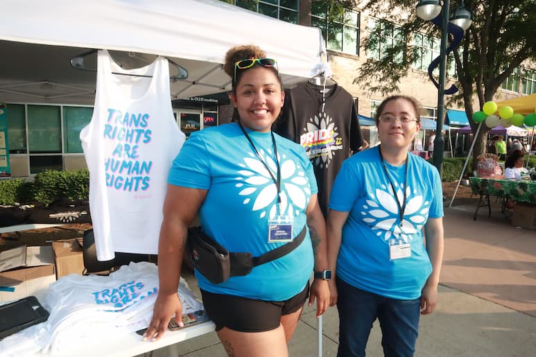 Volunteers with The Project of the Quad Cities along with shirts for sale at the Pride Party at Bass Street Landing in Moline June 17, 2023.