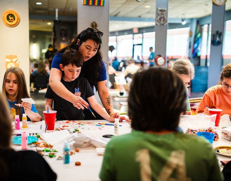 A mom and student at Craft Night at Clock Inc. LGBT+ Community Center in Rock Island with Free Mom Hugs