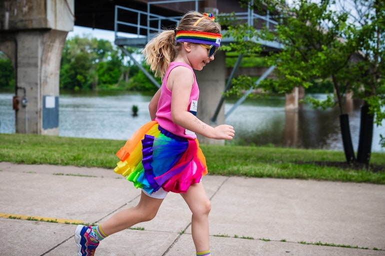 A young runner decked out in a rainbow tutu, headband, shoes and hair ribbon smiles during the Pride 5K in Moline June 15.