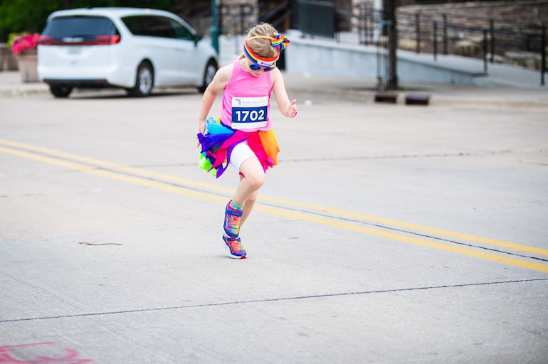 young girl with rainbow tutu, headband and shoes during Pride 5K in Moline June 15