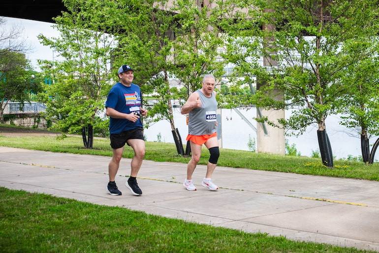 A father and son join in the Pride 5K June 15.