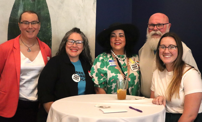 Corina Gonzales and Natasha Hoenig of Free Mom Hugs, Kurt Stevens of Clock Inc. and MCC of the Quad Cities, and Tyler Lanz of the Mississippi Valley Workforce Development Board at the Davenport launch